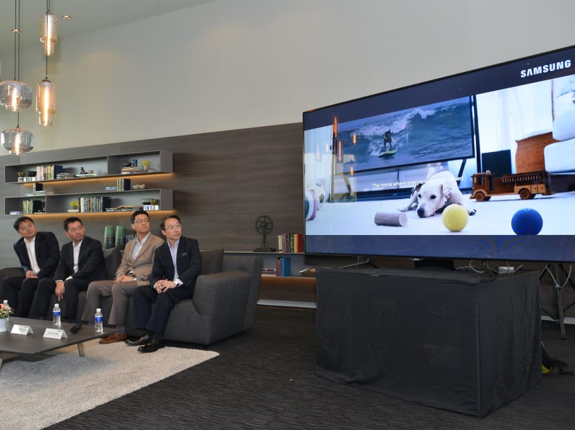 (From left) Qingjian Realty (South Pacific) Group's General Manager Li Jun and Executive Director Song Xiu Yi, and Samsung Asia's President Stephen Suh and Enterprise Business General Manager Andy Sim view Samsung’s video on smart homes of the future. Photo: Qingjian/ Samsung