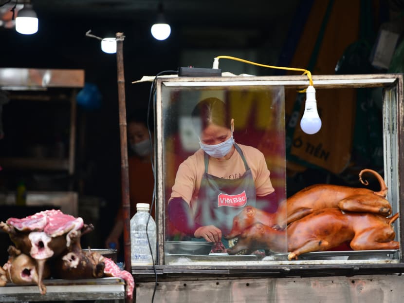 A vendor chops dog meat in Hanoi on Dec 10, 2021. A vendor chops dog meat in Hanoi on Dec 10, 2021.