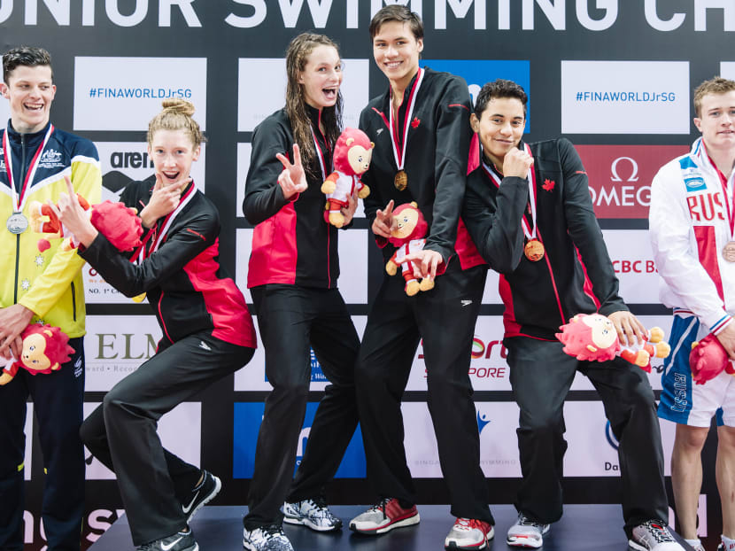 Canada’s swimmers celebrating on the podium after winning the 4x100m freestyle mixed medley at the 5th FINA World Junior Swimming Championships. Photo:  Adrian Seetho / SSA