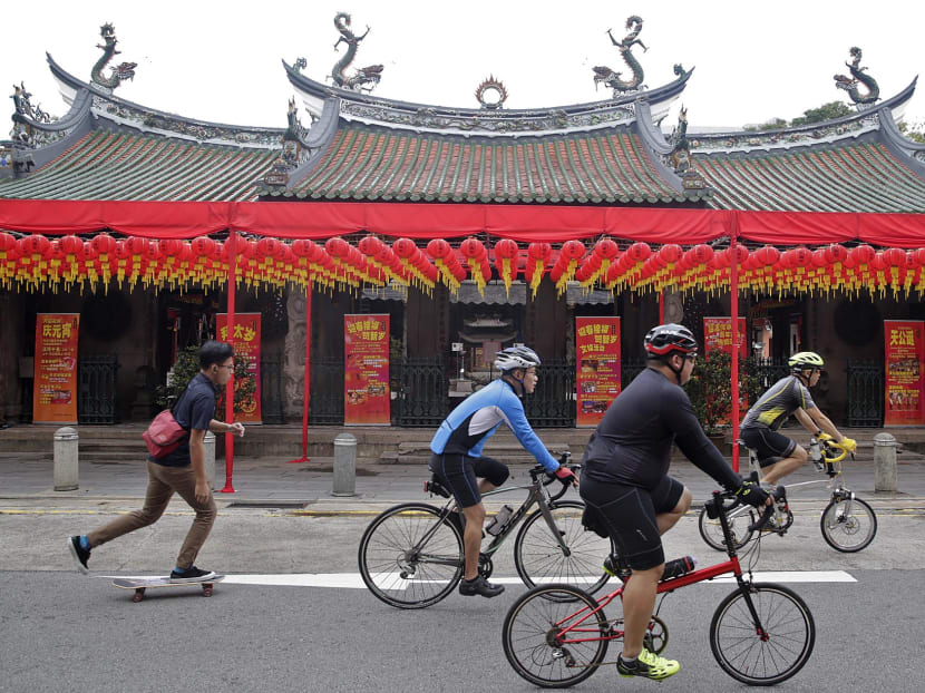 Cyclists and a skateboarder are seen in front of Thian Hock Keng Temple during the Car-Free Sunday SG on Jan 22, 2017. The event was brought forward by one week as the Chinese New Year holidays fall on the last weekend of the month. Photo: Wee Teck Hian/TODAY