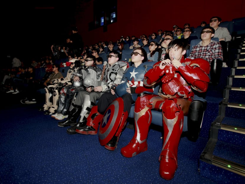 A group of fans dressed in homemade replica armours of "Avengers: Age of Ultron" movie characters, Iron Man, Captain America and Thor, watch the film in a theatre in Changchun, Jilin province, China, May 16, 2015. Photo: Reuters
