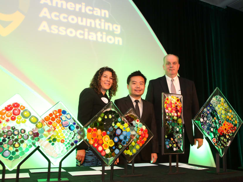 SMU’s Associate Professor of Accounting (Education) Seow Poh Sun (centre), with Ellen J Glazerman, executive director, Ernst & Young Foundation (left) and Professor of accounting and management information systems Guido Geerts, who is also Chair of the Innovation in Accounting Education Award Committee; at the 2015 AAA Annual Meeting held in Chicago. Photo: American Accounting Association.
