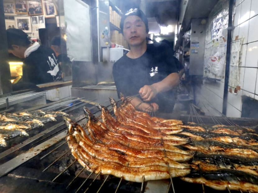 Eels are broiled at a restaurant in Osaka, western Japan, on July 25, 2017, as the day falls on "Doyo-no-ushi-no-hi," or the midsummer day of the ox, when Japanese customarily eat eels in the hope of beating the summer heat. Photo: Kyodo