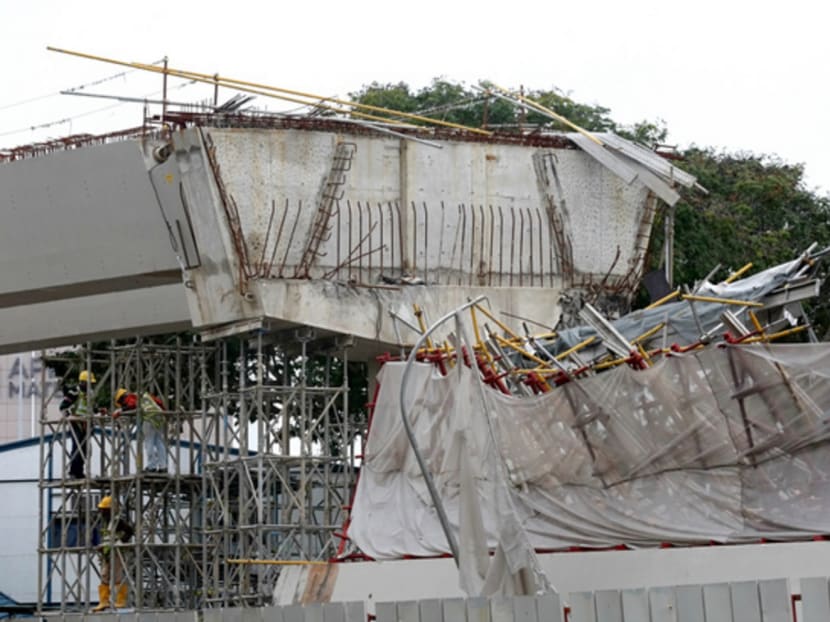 Workers stand on scaffolding beside the collapsed structure  at an LTA worksite along PIE on July 14, 2017. Photo: Nuria Ling/TODAY