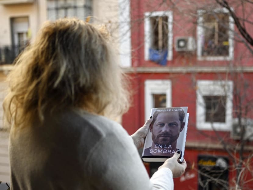 A woman holds the "En la sombra" (In the shadow) Spanish version of the book "Spare" an autobiography by Britain's Prince Harry after buying it in Madrid on Jan 5, 2023, despite the publication date set at Jan 10 with stringent measures in place.
