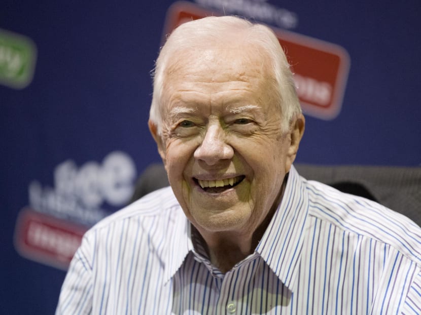 In this July 10, 2015, file photo, former President Jimmy Carter poses for photographs at an event for his new book "A Full Life: Reflections at Ninety at the Free Library in Philadelphia. Photo: AP