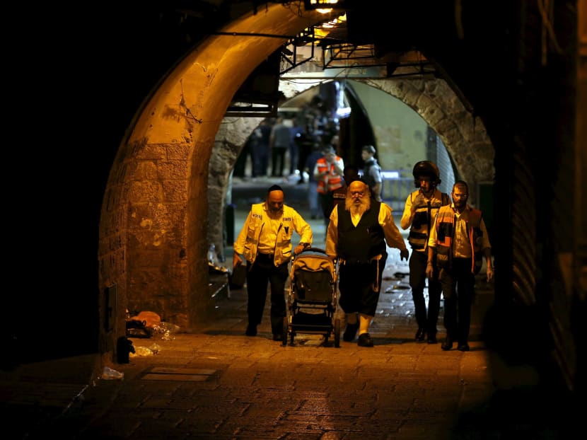Israeli members of the Zaka Rescue and Recovery team push a baby carriage near the scene where a Palestinian was shot dead after he stabbed and killed two people in Jerusalem's Old City October 3, 2015. Photo: Reuters