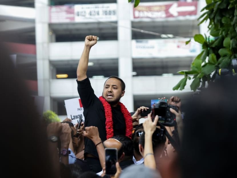 Farhash Wafa Salvador Rizal Mubarak gestures to the crowd as he leaves the Dang Wangi police station in Kuala Lumpur on Tuesday, July 23, 2019.