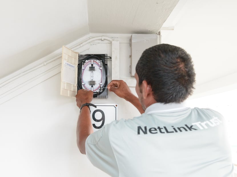 A NetLink Trust employee installing an optical fibre point. Photo: NetLink Trust
