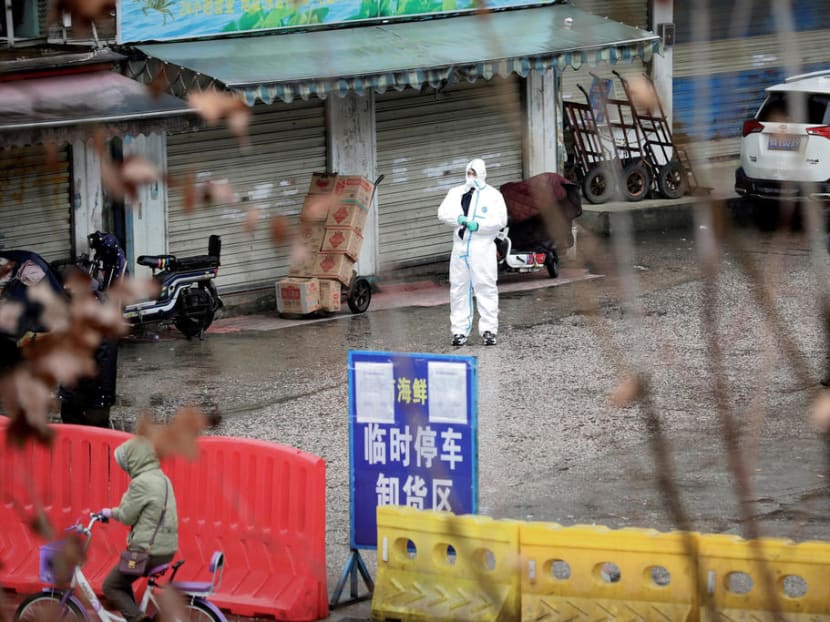 A worker in a protective suit at a closed seafood market in Wuhan, China, on Jan 20, 2020.