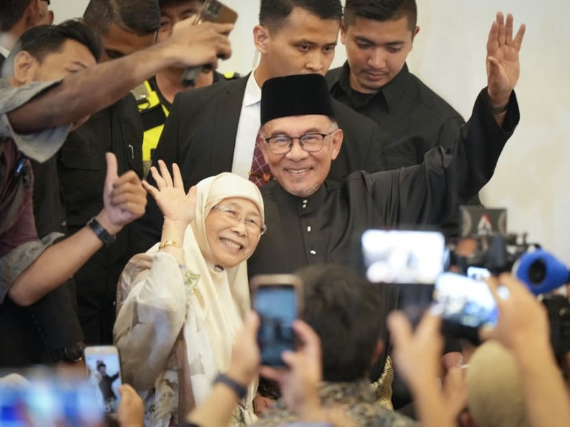 Malaysia's newly appointed prime minister Anwar Ibrahim and his wife Wan Azizah waving as they arrive ahead of his press conference in Kuala Lumpur, Malaysia on Nov 24, 2022. 