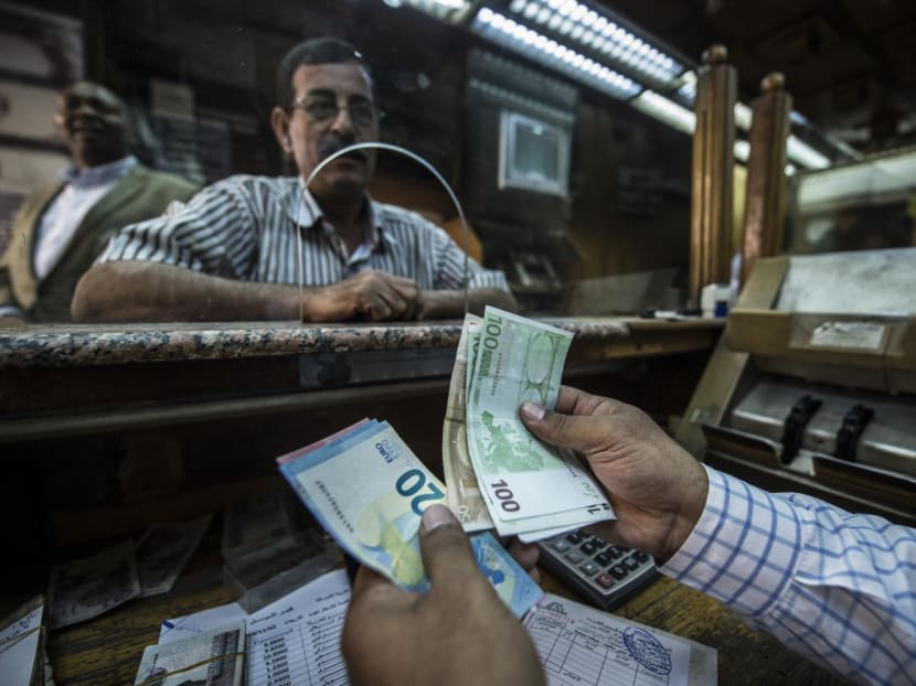 In this file photo an employee counts banknotes at currency exchange shop in the Egyptian capital Cairo on Nov 3, 2016.