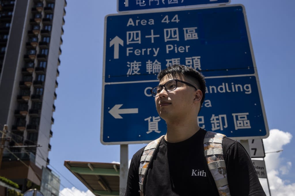 This picture taken on July 10, 2022, in Hong Kong shows Mr Gary Yau standing in front of a street sign that was manually designed and handmade by prison inmates between the 1970s and 1990s. This picture taken on July 10, 2022, in Hong Kong shows Mr Gary Yau standing in front of a street sign that was manually designed and handmade by prison inmates between the 1970s and 1990s.