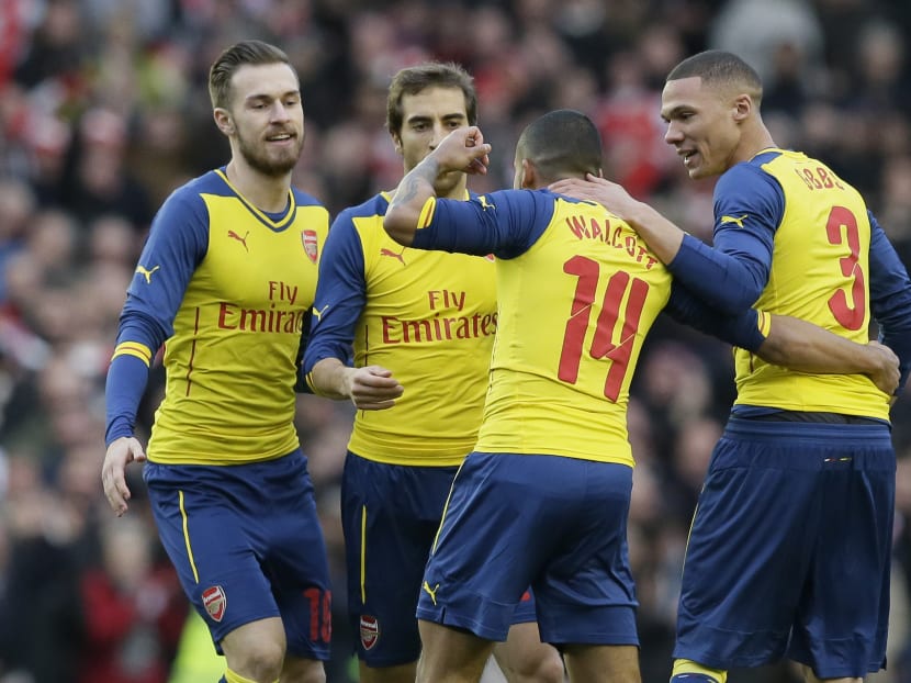 Arsenal’s Theo Walcott (second right) celebrates after scoring a goal during the English FA Cup 4th round soccer match between Brighton & Hove Albion and Arsenal at the Amex Stadium, Brighton, England, Jan 25, 2015. Photo: AP