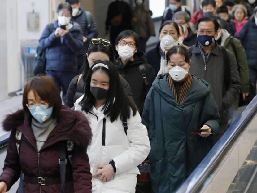 Passengers arriving from the Chinese city of Wuhan arrive at Narita Airport in Chiba, Japan in this photo taken by Kyodo on Jan 23, 2020.