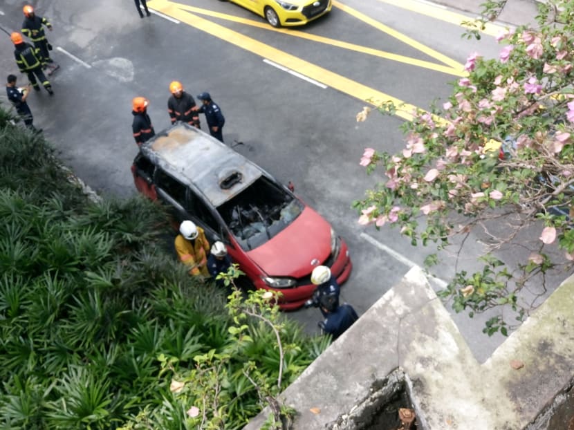 The Trans-cab taxi which caught fire on Monday afternoon along Marymount Road. Photo: Faris Mokhtar/TODAY
