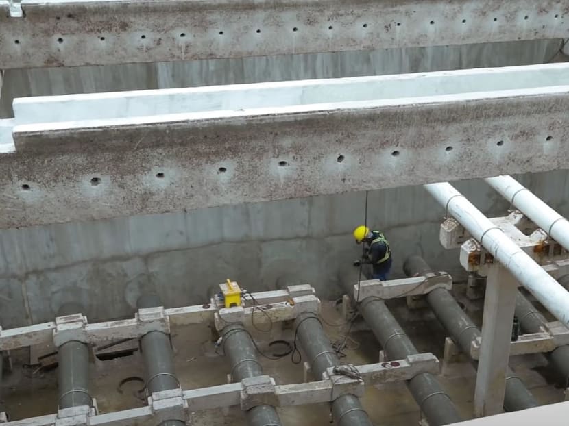A man carrying out upgrading works at Choa Chu Kang Waterworks in 2019.