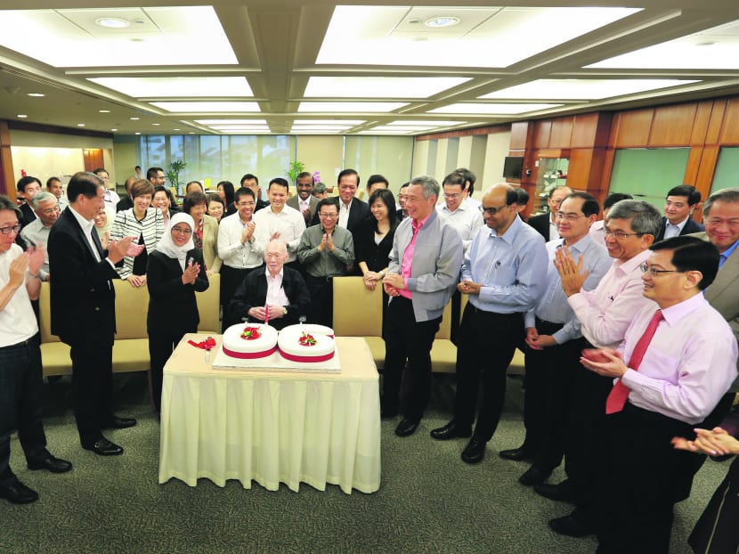 Prime Minister Lee Hsien Loong and MPs celebrating Mr Lee Kuan Yew’s (centre) birthday at Parliament House yesterday. Mr Lee turned 90. Photo: MCI