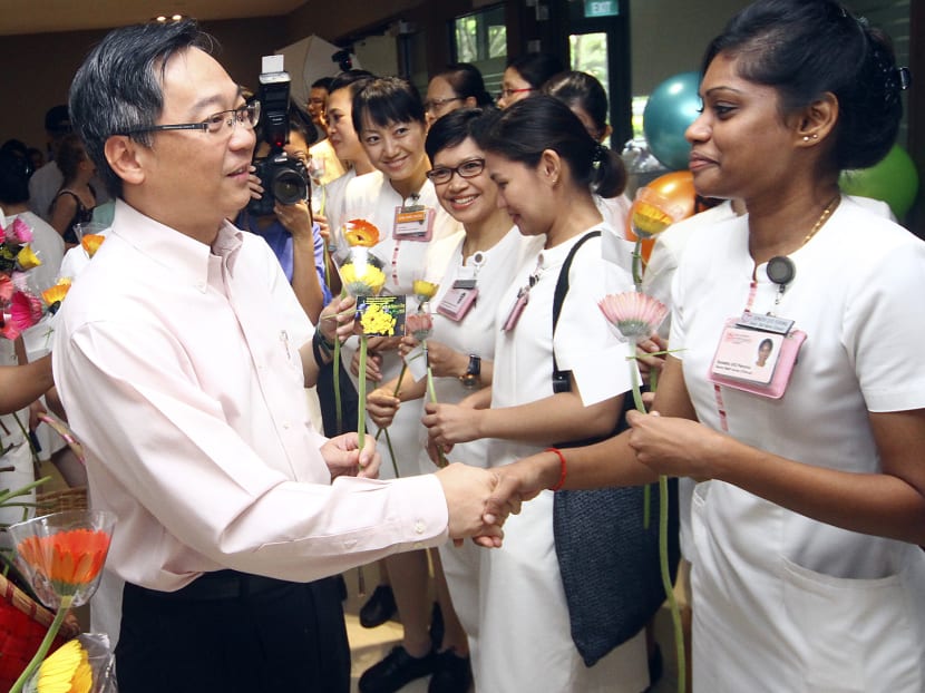 Minister of Health Mr Gan Kim Yong greets nurses with flowers on Nurses' Day, August  1, 2014. Photo: Ernest Chua