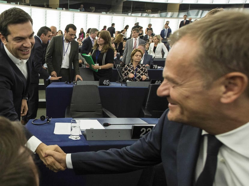 Greek Prime Minister Alexis Tsipras, left, shakes hands with Donald Tusk, president of the European Council, before delivering his speech at the European Parliament in Strasbourg, eastern France, Wednesday, July 8, 2015.  Photo: AP