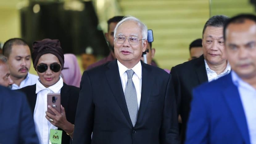 Unfazed by graft trial proceedings, ex-PM Najib reads, chats during breaks