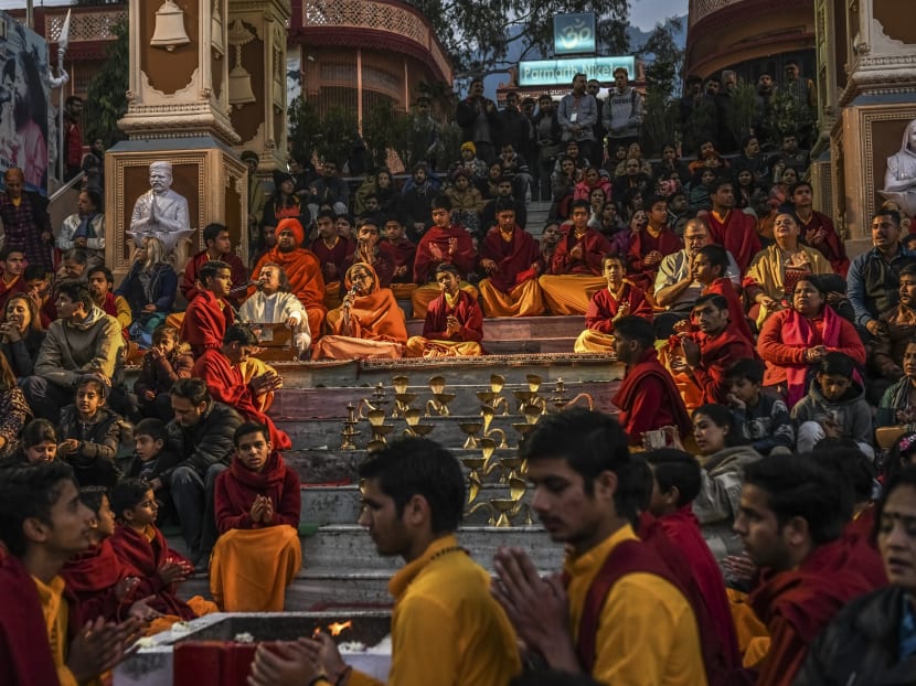 Religious students and tourists during a nightly ritual at the Parmath Niketan ashram in Rishikesh, India, Dec. 23, 2017. Over the years, as more spiritual seekers from the West traveled to India looking for enlightenment, Rishikesh ballooned in size. But when The Beatles arrived, the place was a sleepy town straddling the banks of the Ganges. Photo: The New York Times