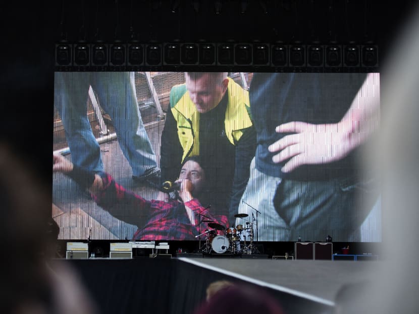 Foo Fighters' Dave Grohl is pictured on a big screen talking in a microphone after falling from the stage, during the band's concert at Nya Ullevi in Gothenburg, Sweden, Friday, June 12, 2015. Photo: AP