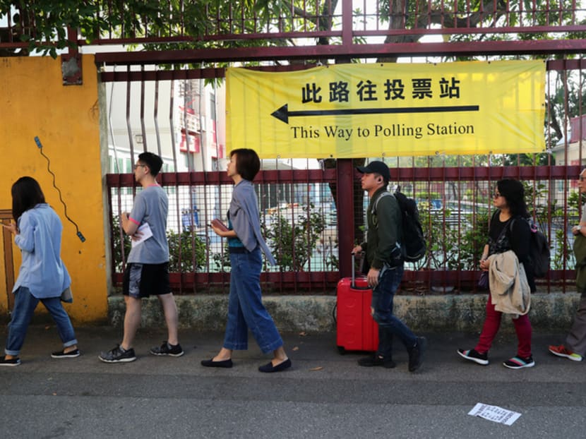 Voters queue up outside a polling station during district council local elections in Hong Kong, China on Nov 24, 2019.