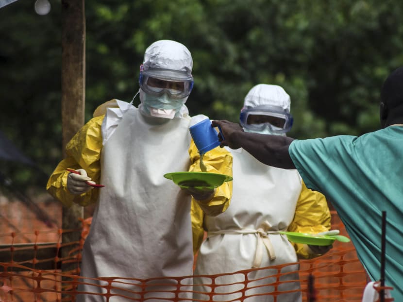 Medical staff working with Medecins sans Frontieres (MSF) prepare to bring food to patients kept in an isolation area at the MSF Ebola treatment centre in Kailahun July 20, 2014. Photo: Reuters