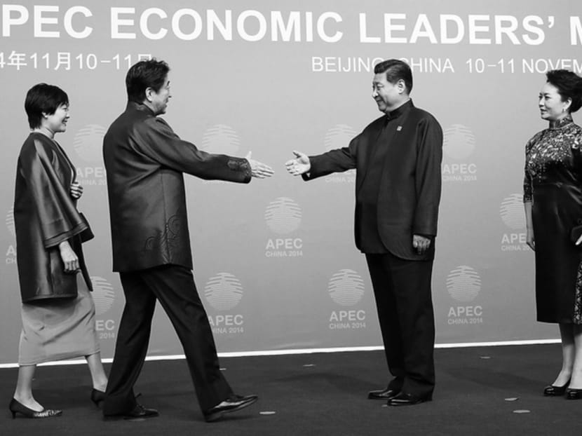 Mr Abe greeting Mr Xi as their wives looked on at the APEC Welcome Banquet in Beijing on 
Nov 10. The meeting between both leaders is a signal that they recognise the rationale to get on. Photo: Reuters