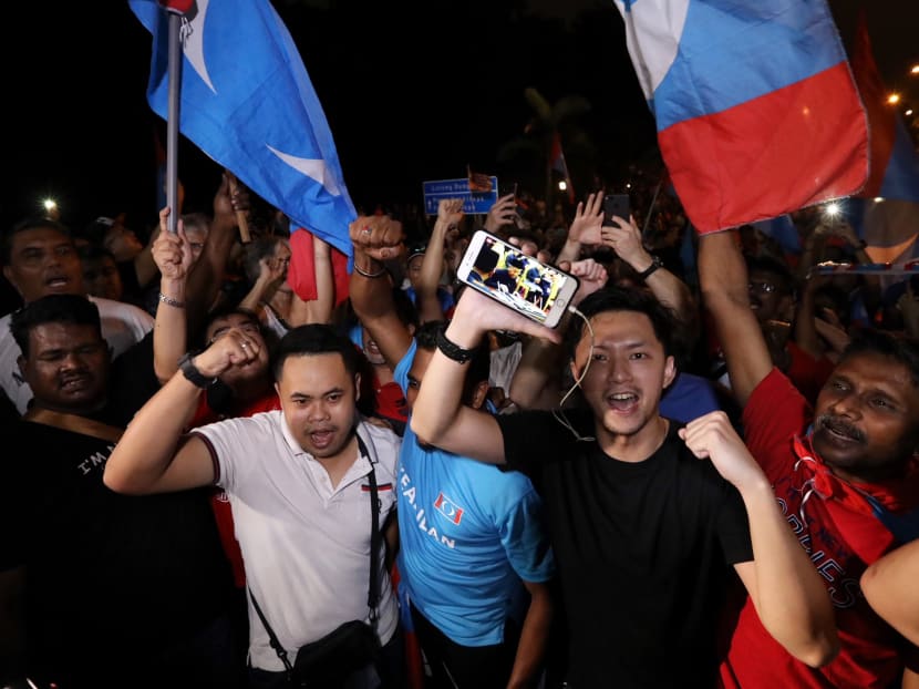 Pakatan Harapan supporters watching Dr Mahathir Mohamad being sworn in as the 7th Prime Minister of Malaysia on their mobile phones outside the the Istana Negara in Kuala Lumpur.