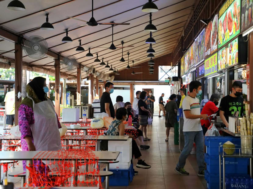 Under current Covid-19 measures, people are only allowed to dine in groups of two at coffee shops and hawker centres, regardless of their vaccination status.