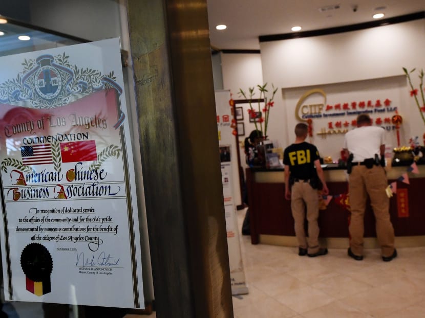 FBI agents inspect the offices of the California Investment Immigration Fund after serving search warrants in an investigation into an alleged USD 50 million high-end visa fraud scheme involving as many as 100 Chinese nationals in San Gabriel, California on April 5, 2017. Photo: AFP