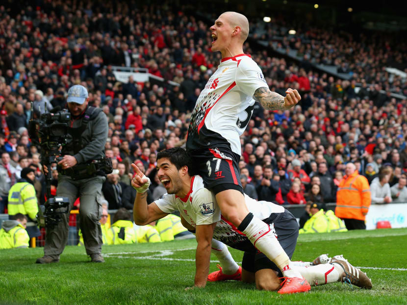 Liverpool's Luis Suarez celebrates scoring his team's third goal with Martin Skrtel (right) during the English Premier League match between Manchester United and Liverpool at Old Trafford on March 16, 2014. Photo: Getty Images