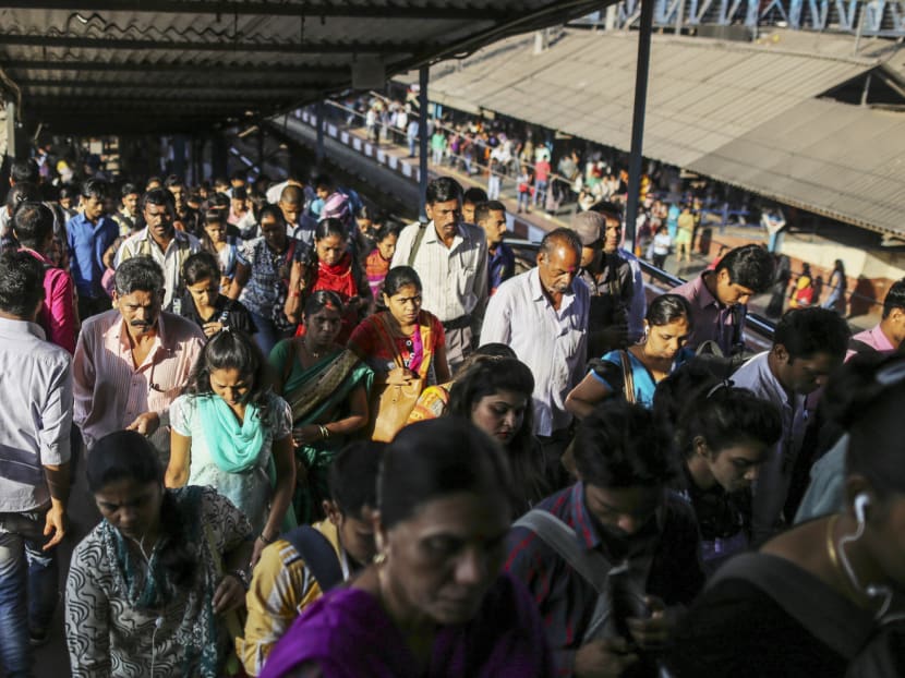Commuters walking along a bridge at the Kurla railway station in Mumbai. Yesterday’s elections mark a political transition after the ruling Shiv Sena-BJP alliance split earlier this year. Photo: Bloomberg
