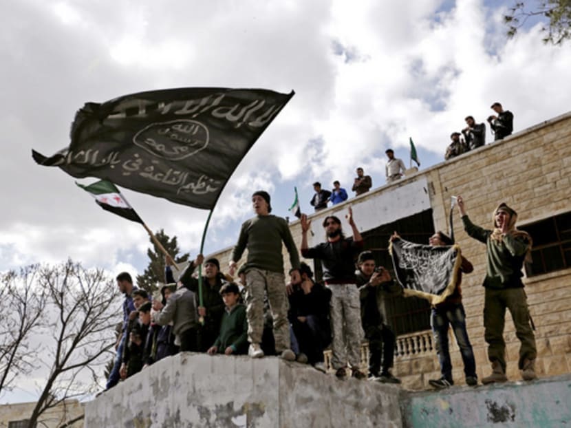 Protesters carrying Al Qaeda flags during an anti-government protest in the town of Maarat Numan in Idlib province, Syria. Al Qaeda militants in Syria and Yemen have seized on chaos to take control of significant territory, presenting themselves as an alternative to the brutality of IS rule . Photo: REUTERS