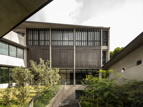 This fortress-like concrete house in Singapore hides a surprise within