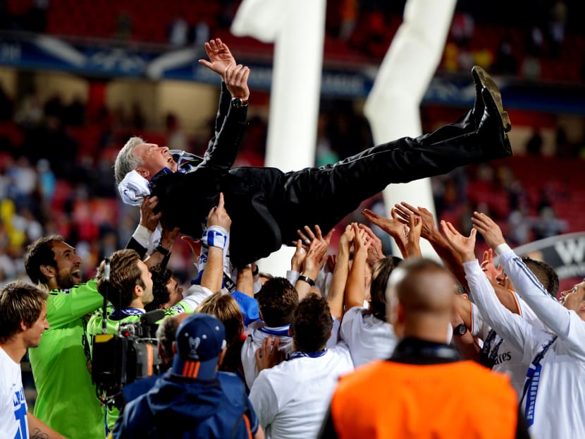 Carlo Ancelotti, then head coach of Real Madrid, being lifted in celebration by his players. The coach is unusual in that he is not associated with any particular style ­— he slides into great clubs, wins prizes commensurate with their station and moves on without leaving his imprint. Photo: Getty Images
