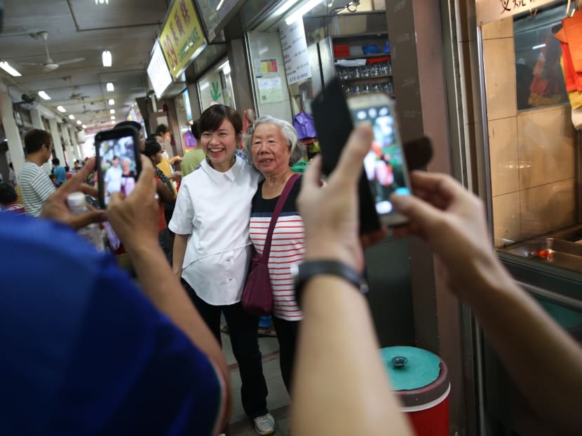 Tin Pei Ling obliges for a photo during her visit to Mcpherson Market and Food Centre. Photo: Jason Quah