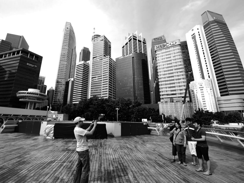 Tourists in Singapore’s CBD. Previously judged an important industry, tourism is now low value-add compared with knowledge-based sectors like finance. Photo: Bloomberg
