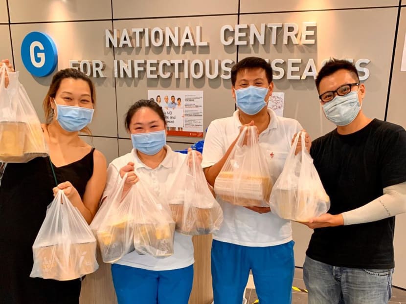 Mr Benjamin Lim (right), brand manager of Woobbee, donating bubble tea to staff members from the National Centre for Infectious Diseases.