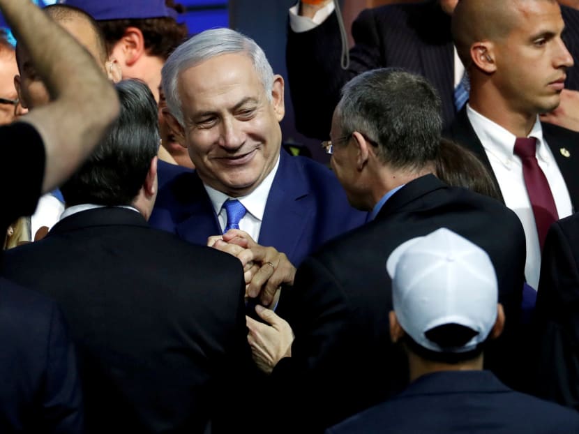 Israeli Prime Minister Benjamin Netanyahu is greeted by supporters of his Likud party as he arrives to speak following the announcement of exit polls in Israel's parliamentary election at the party headquarters in Tel Aviv, Israel, April 10, 2019.