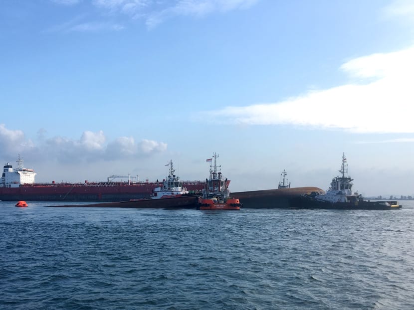 Four tug boats moving the partially submerged dredger safely to an area near Pulau Senang for follow up underwater search operation. Photo: MPA