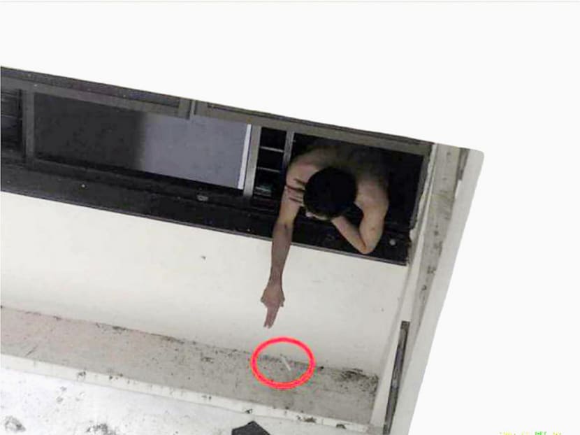 A screenshot of the man throwing a cigarette from his unit. He was fined S$600 per charge for 33 charges and sentenced to five hours of CWO for one charge. Photo: NEA