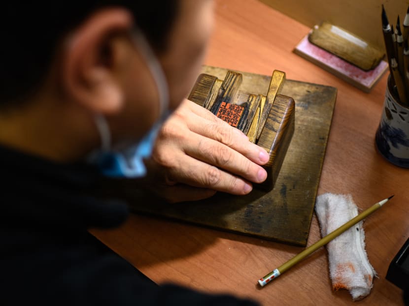 Traditional ink stamp-maker Takahiro Makino, 44, working on a hanko in Tokyo on Oct 9, 2020. Hanko or traditional ink stamps are used to sign everything from delivery receipts to marriage certificates in Japan, and a push to digitise the nation and phase them out faces an uphill struggle.
