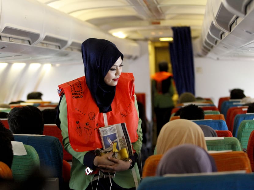 A female cabin crew checks on passengers aboard Rayani Air, Malaysia’s first shariah-compliant airline. The Malaysian Insider file photo.