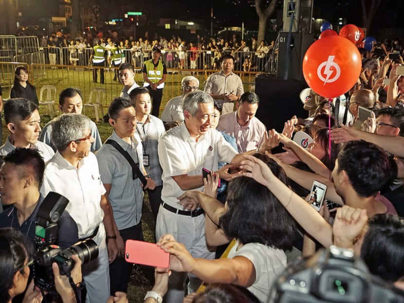 PM Lee with supporters from Jalan Besar GRC after the rally held in a field in front of Block 4, Boon Keng Road. Mr Lee said despite the fanfare at its rallies, the Opposition’s statements are often inconsistent. Photo: Ray Chua