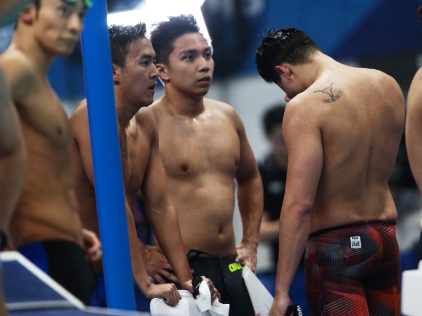 Team Singapore's 4x100m medley men's relay team, comprising of Quah Zheng Wen, Lionel Khoo, Joseph Schooling, and Darren Lim, react to finishing fourth in a time of 3min 37.68sec.