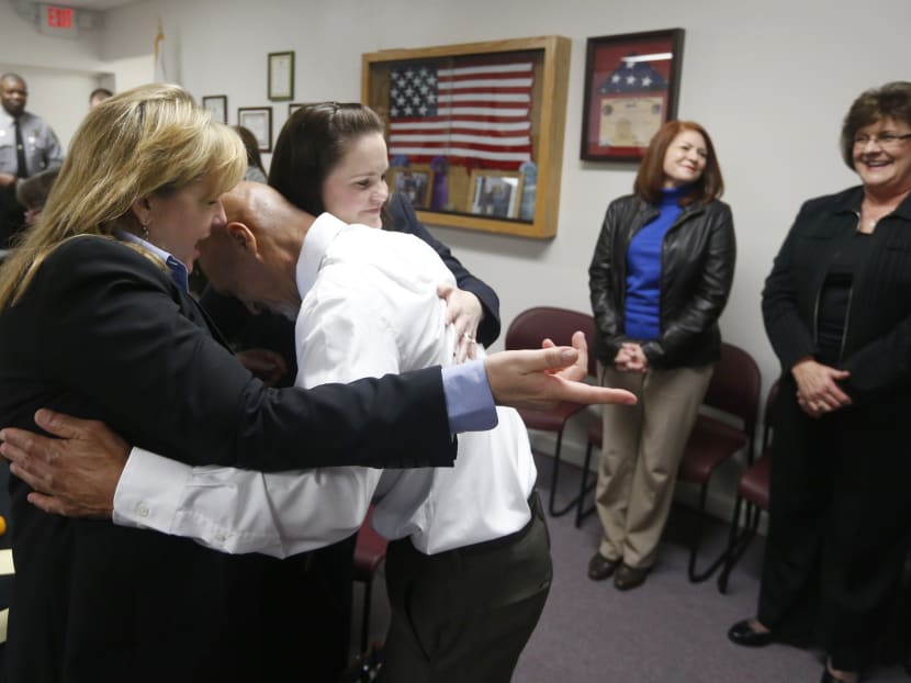 Mr Joseph Sledge (centre) hugs his attorney Christine Mumma, director of the North Carolina Center on Actual Innocence, left, and Cheryl Sullivan, staff attorney, after a special session of superior court. Photo: AP