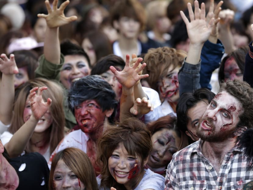 About 1,000 beauty schools students and fun-seekers dressed up as zombies and descended on Tokyo Tower today. Photo: AP